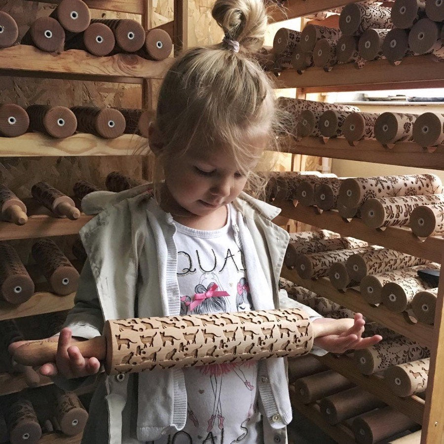 Karolina's daughter in the workshop in 2017, holding a rolling pin